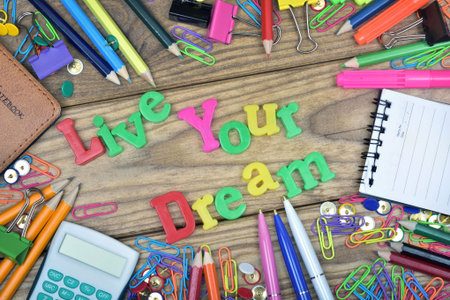 Live your dream text and office tools on wooden table