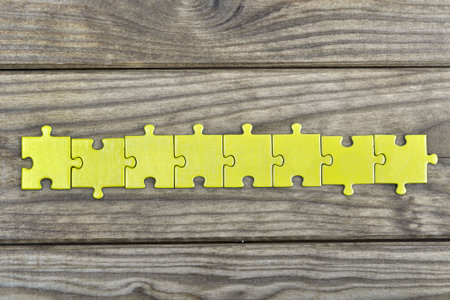 Puzzle pieces on wooden tableの写真素材