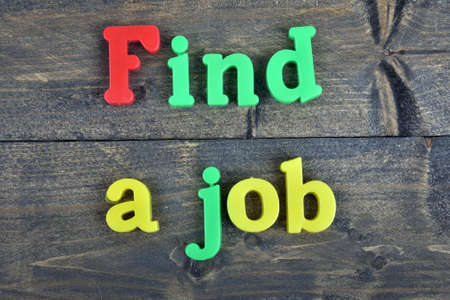 Find a job word on wooden tableの写真素材