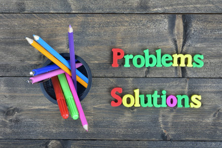 Problems and Solutions word on wooden tableの写真素材
