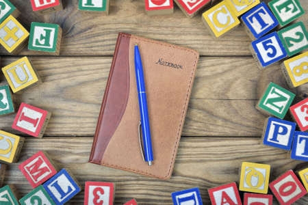 Notepad on wooden tableの写真素材