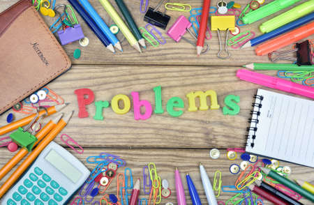 Problems word and office tools on wooden tableの写真素材
