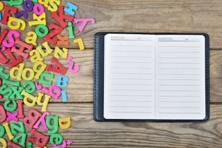 Notepad  and many letters on wooden tableの写真素材