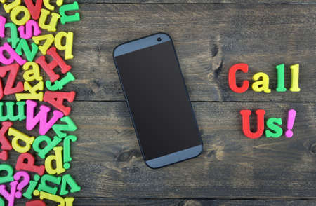 Call Us word on wooden table