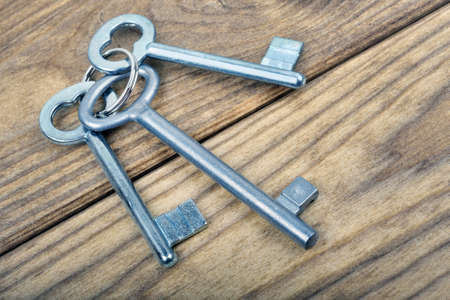 Closeup of keys on wooden tableの写真素材