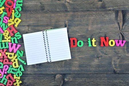 Do it now word on wooden tableの写真素材