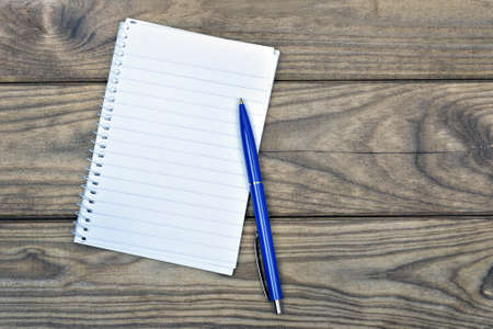 White notebook on wooden tableの写真素材