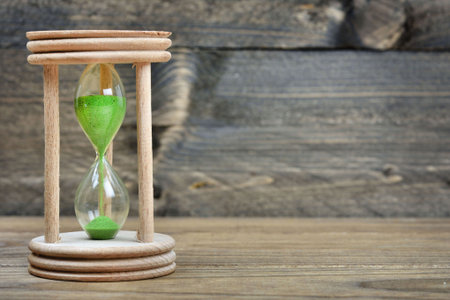 Hourglass on wooden tableの写真素材