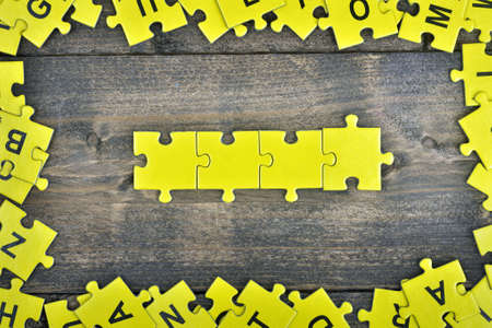 Puzzle pieces on wooden tableの写真素材