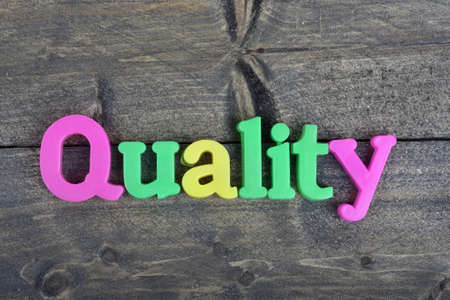 Quality word on wooden tableの写真素材