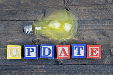 Bulb and word Update on wooden tableの写真素材