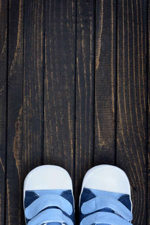Kid shoes on wooden floorの写真素材