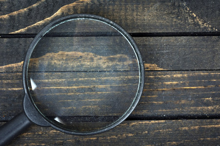 Magnifying glass on wooden tableの写真素材