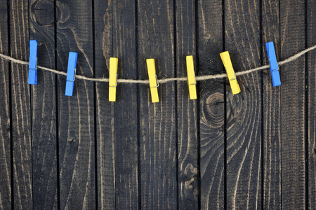 Seven clips on wooden wall