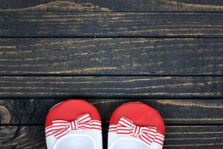 Kid shoes on wooden floorの写真素材