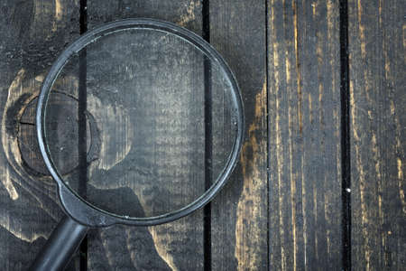 Magnifying glass on wooden tableの写真素材