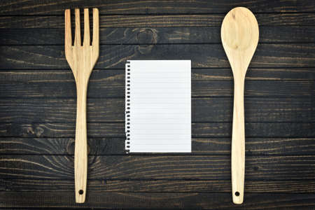 Kitchen utensils and empty page on wooden tableの写真素材