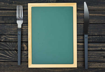 Fork and knife on wooden tableの写真素材