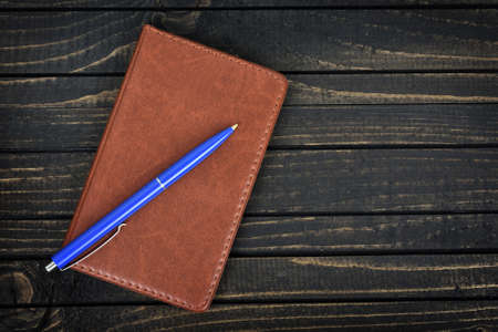 Notepad on wooden tableの写真素材