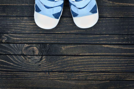 Kid shoes on wooden floorの写真素材