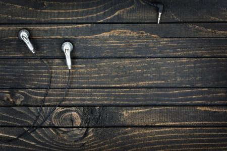Earphones closeup on wooden tableの写真素材