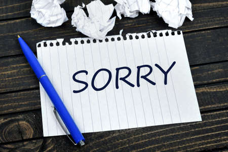 Sorry text on notepad and crippled paperの写真素材