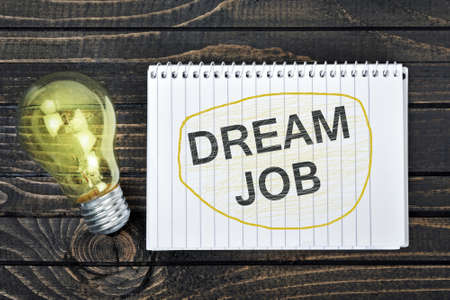 Dream Job text on notepad and light bulbの写真素材
