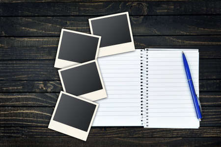 Empty page and instant photos on wooden tableの写真素材