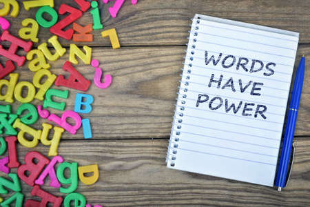 Words have power text on notepad and magnetic letters on wooden tableの写真素材