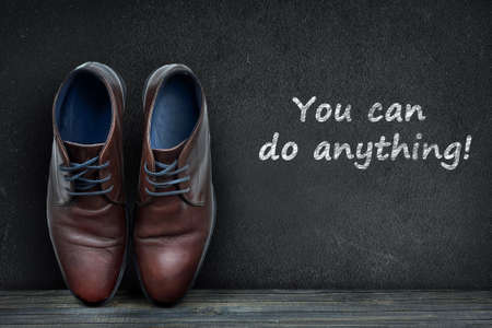 You can do anything text on black board and business shoes on wooden floorの写真素材