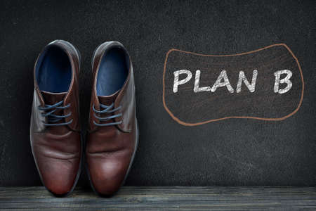 Plan B text on black board and business shoes on wooden floorの写真素材