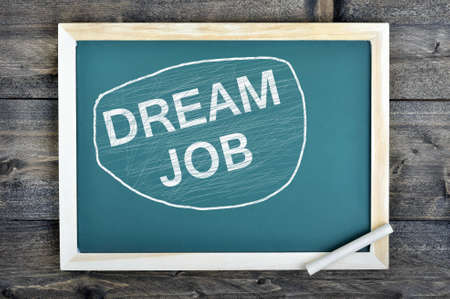 Dream Job text on school board and chalk on wooden tableの写真素材