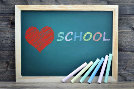 Love School text on school board and chalk on wooden tableの写真素材