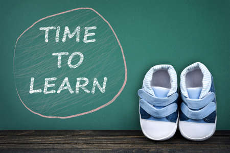 Time to learn text on school table and kid shoesの写真素材