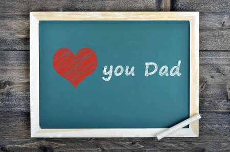 Love dad text on school board and chalk on wooden tableの写真素材