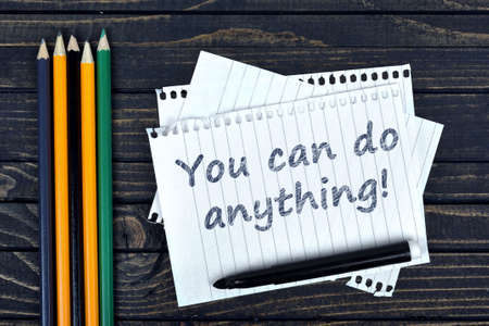You can do anything text on notepad and office tools on wooden tableの写真素材