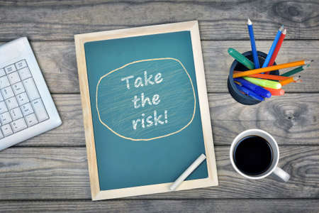 Take the risk text on school board and coffee on deskの写真素材