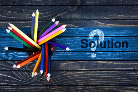 Solution text painted and group of pencils on wooden tableの写真素材