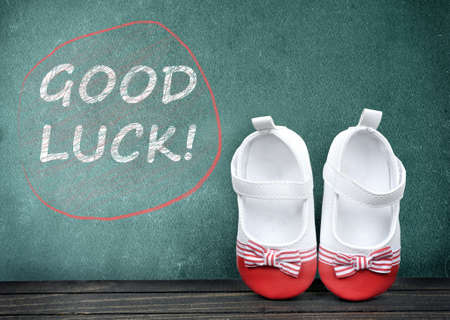 Good Luck text on school table and kid shoesの写真素材