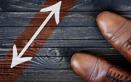 Arrows message and business shoes on wooden floor