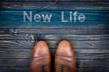 New Life message and business shoes on wooden floorの写真素材