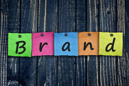 Brand message post on wooden wall close-upの写真素材