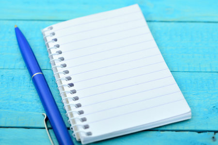 Empty notepad on wooden tableの写真素材