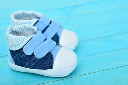 Kid shoes on wooden floorの写真素材