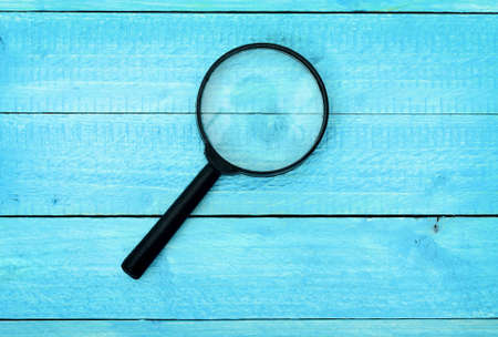 Magnifying glass on wooden tableの写真素材