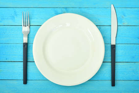 White plate on wooden tableの写真素材