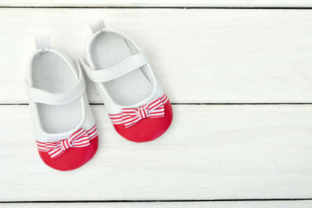 Kid shoes on wooden floorの写真素材