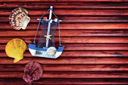 Toy ship and sea shells on blue wooden tableの写真素材
