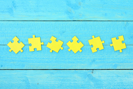 Puzzle pieces on wooden tableの写真素材