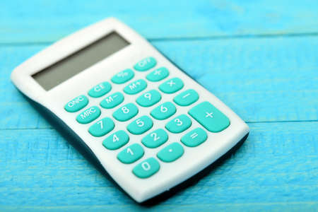 Hand calculator close-up on wooden tableの写真素材